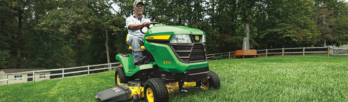 Man driving X350 Select Series Lawn Tractor in yard