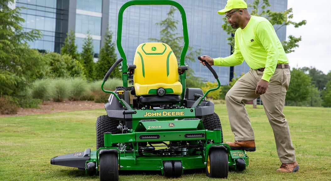 Person getting on a Z760R Zero Turn Mower