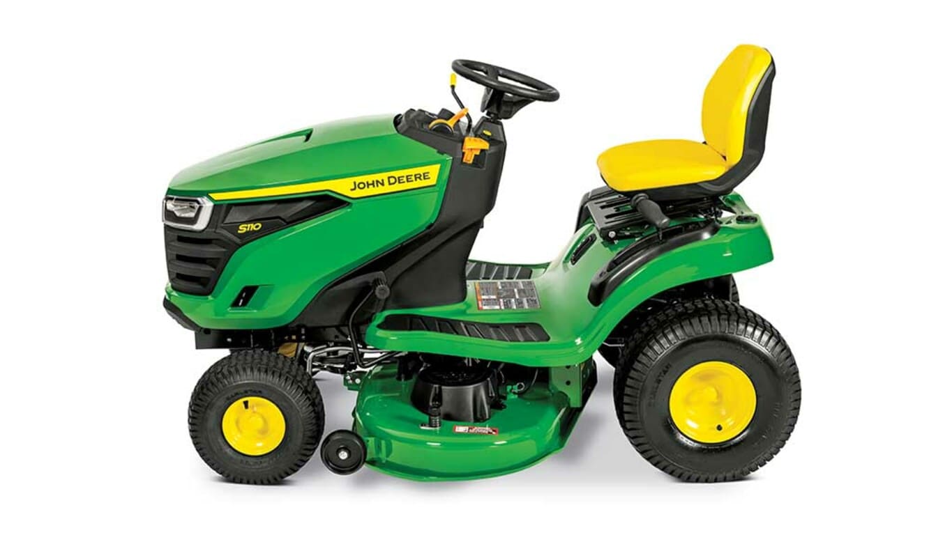 A left-facing green riding mower with a yellow seat and green mowing deck on a white background.