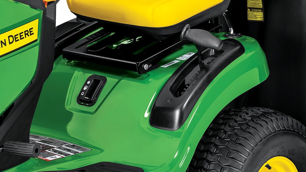 Close-up studio shot of a black lever and notches that lower the mowing deck by 1/4-in. increments.