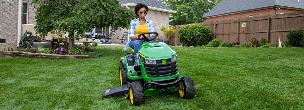  The John Deere S100 100 Series being used to mow a residential lawn
