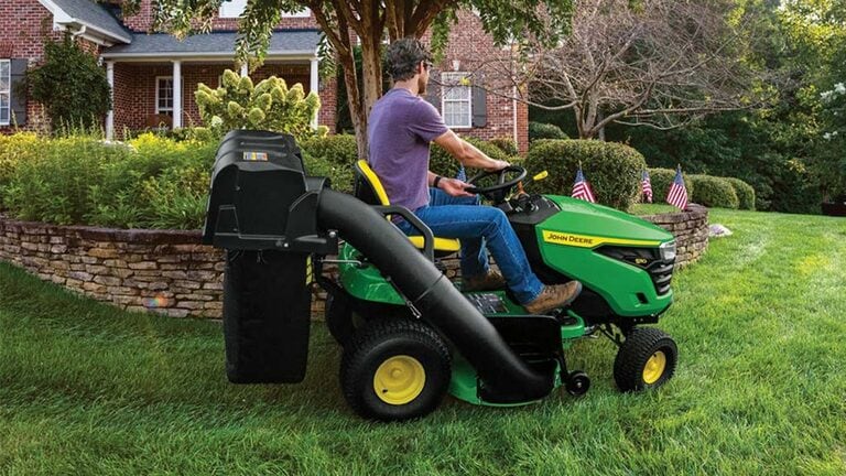 Person riding on a S110 mower using a bagger