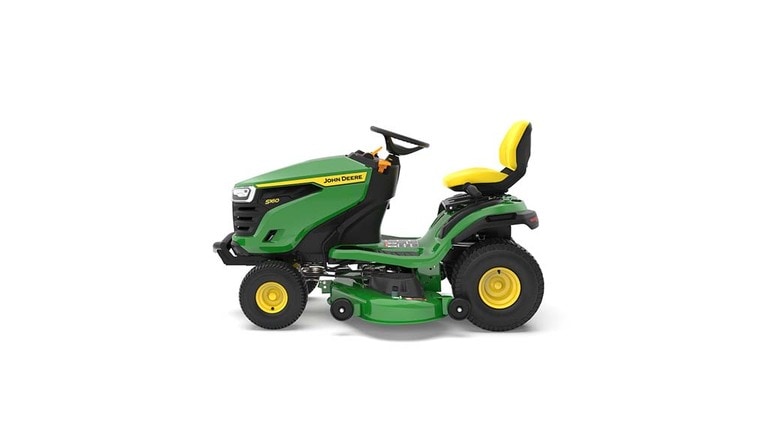 A left-facing green riding mower with a yellow seat and green mowing deck on a white background.