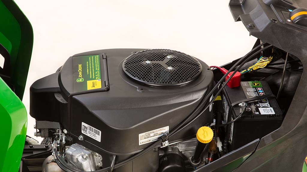 Close-up shot of a V-Twin Engine under the green hood of a mower.