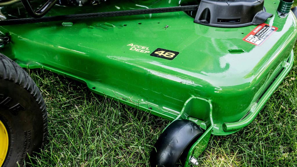 shot of mower going around a rock