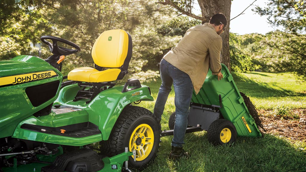 man dumping soil out of a cart