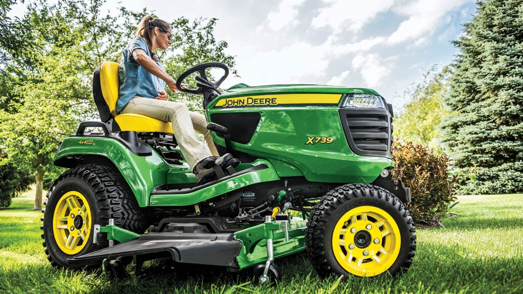 close up of the front end of a X700 series lawn mower with woman driving