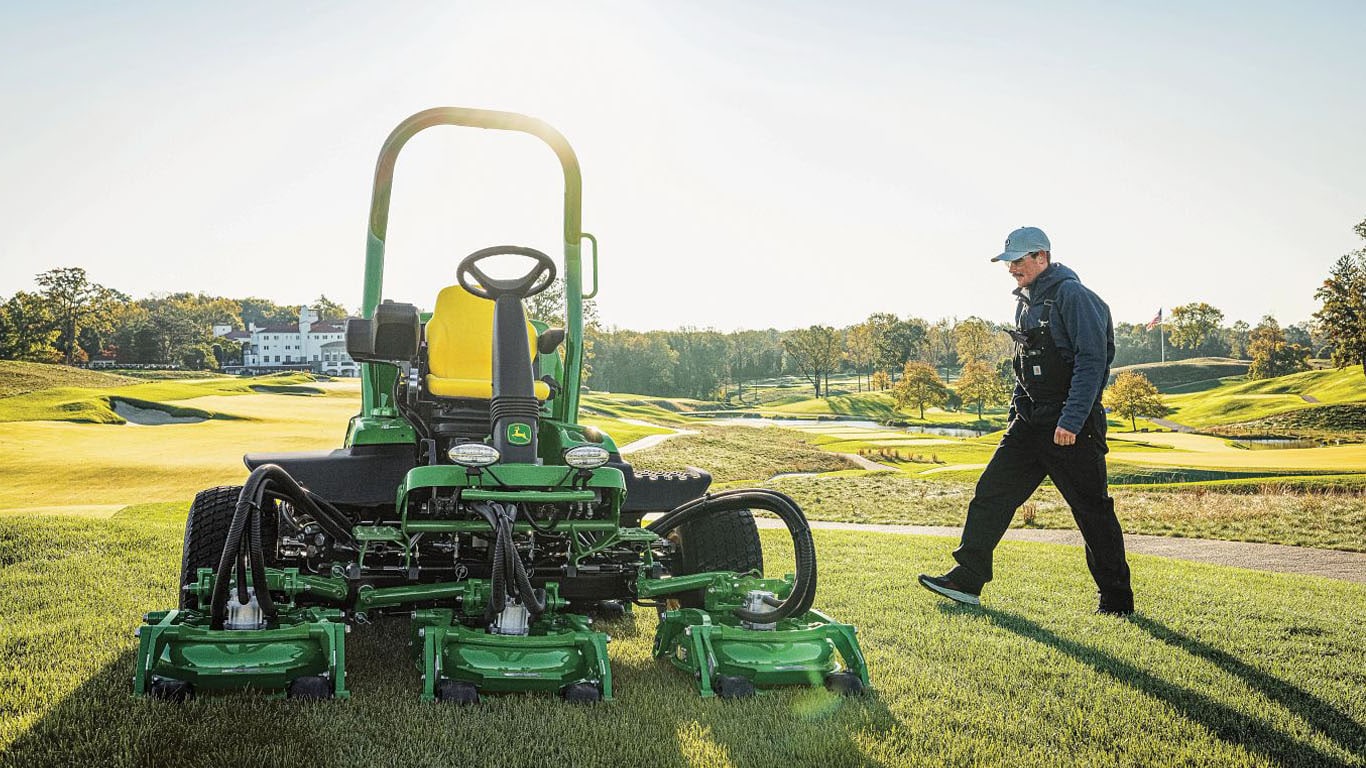TerrainCut parked with superintendent walking towards it
