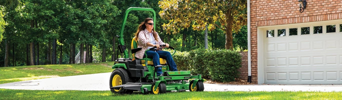 woman driving z500 lawn tractor in yard