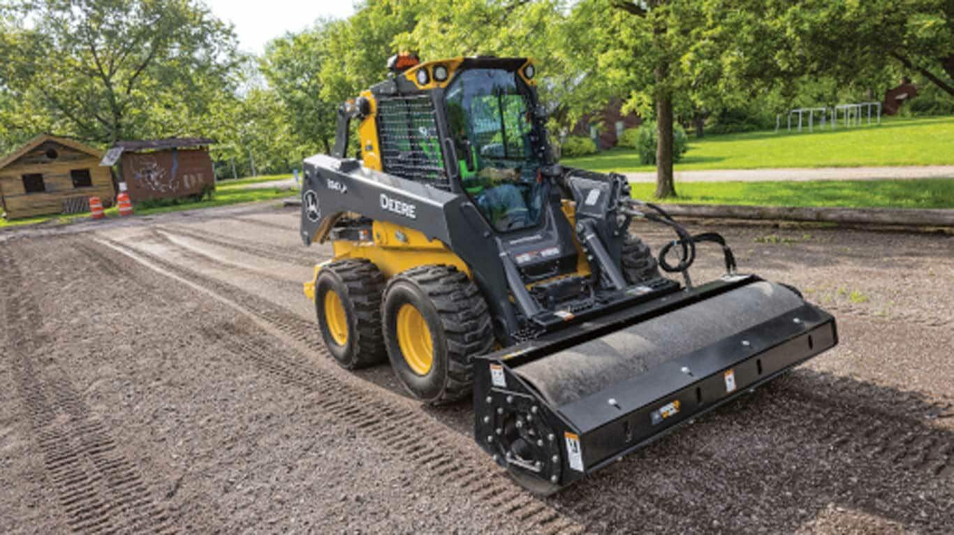 Vibratory Roller attachment on a skid steer with wheels on a jobsite