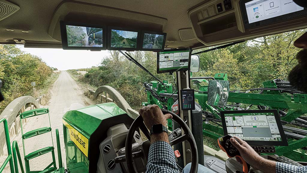 Operator in cab viewing three SmartView displays.