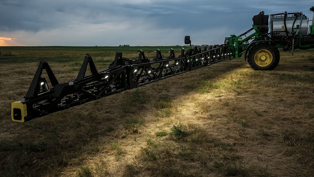 Self-propelled sprayer target spraying at night with the full boom lit up.
