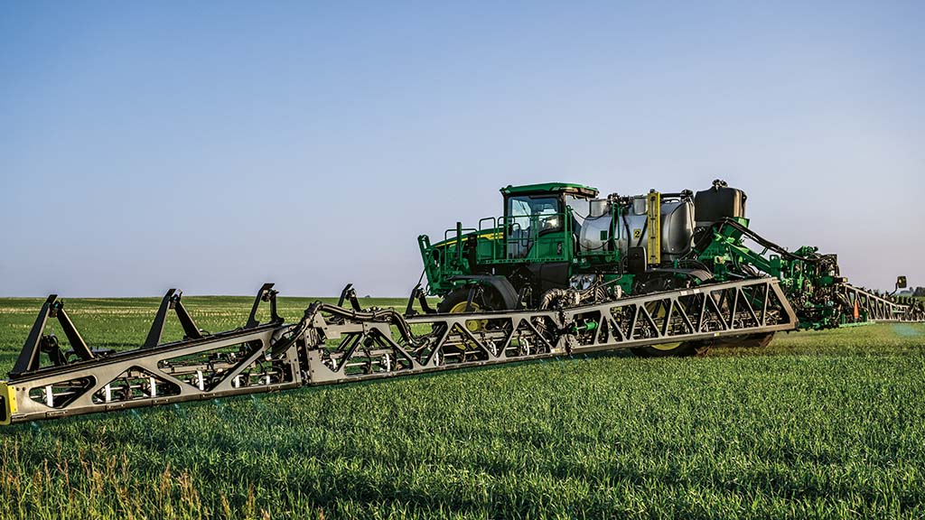 Self-propelled sprayer with full boom extended.