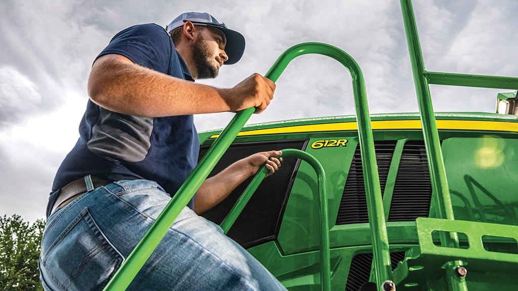 Man climbing up a 612R Sprayer