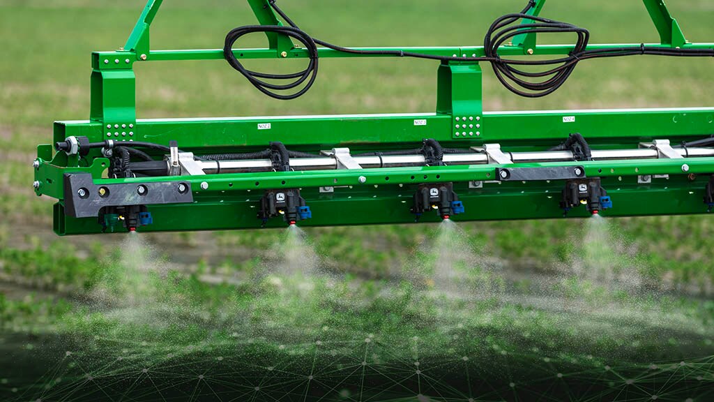 Close-up of a John Deere sprayer boom with spraying with See & Spray™ Premium Precision Upgrade.