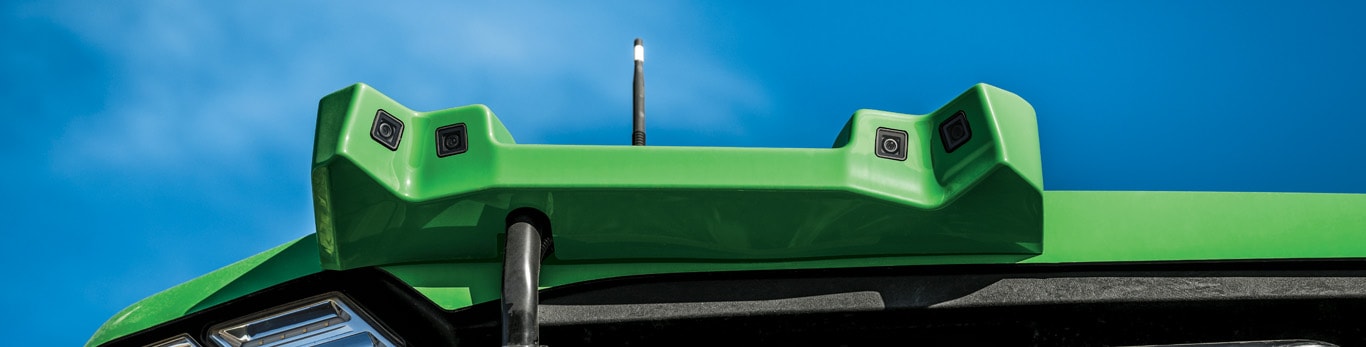 Close-up of autonomous perception system with multiple integrated cameras against a blue sky.