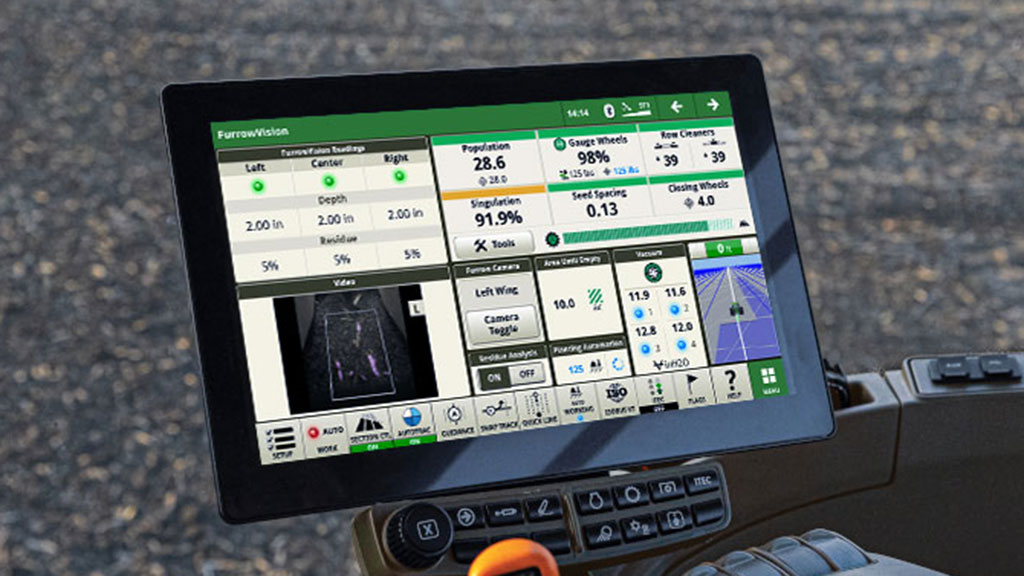Tractor cab dispaly showing the John Deere FurrowVision interface with live planting metrics and a furrow camera feed. Tractor cab dispaly showing the John Deere FurrowVision interface with live planting metrics and a furrow camera feed.