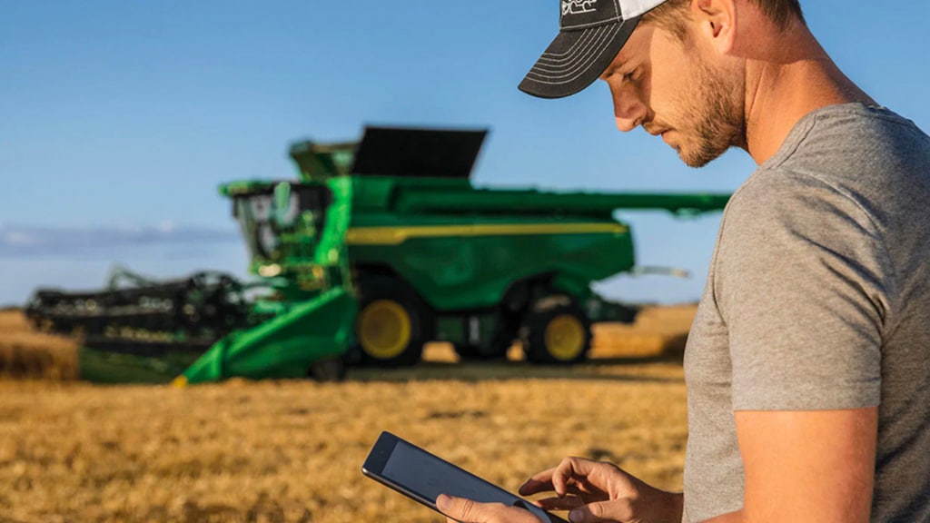 Man looking at tablet in field