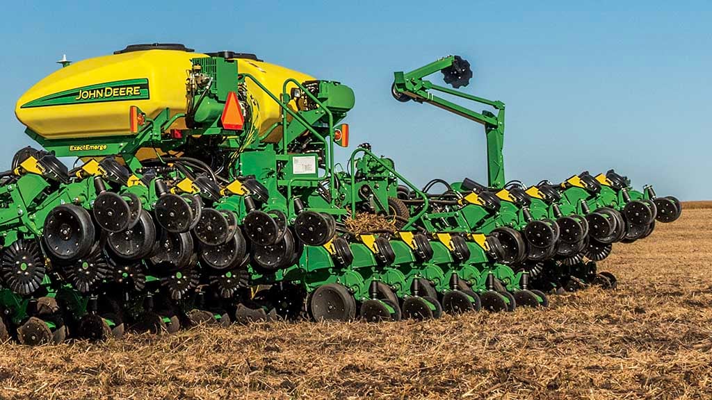 Image of a planter in the field planting seed