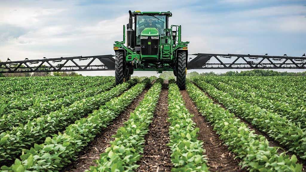 A sprayer in soybean field.