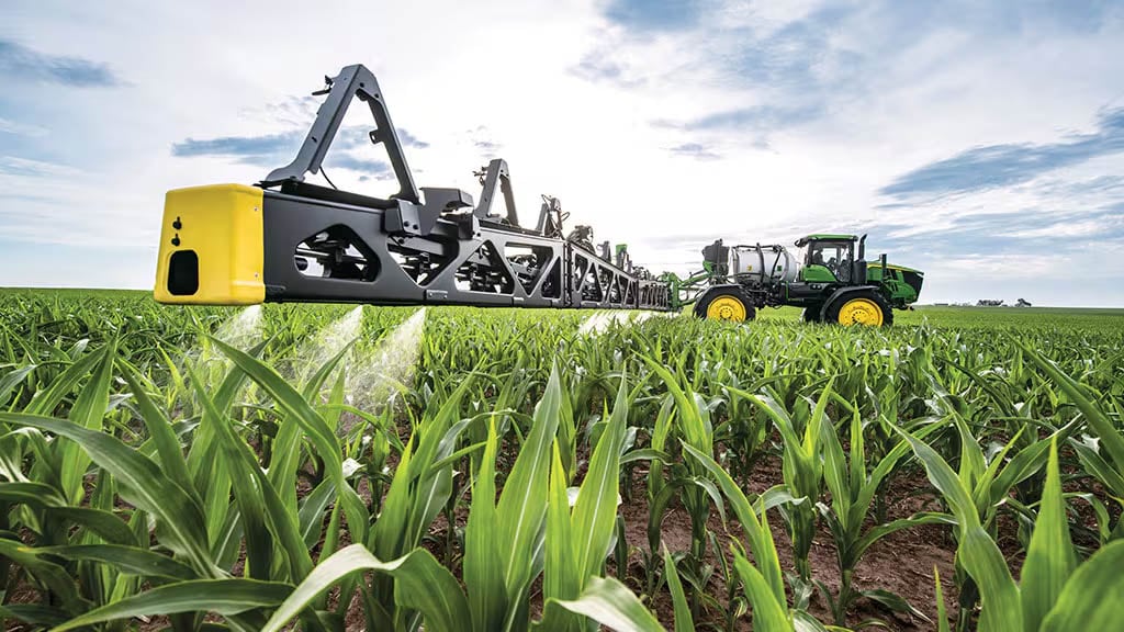 A sprayer in corn field.