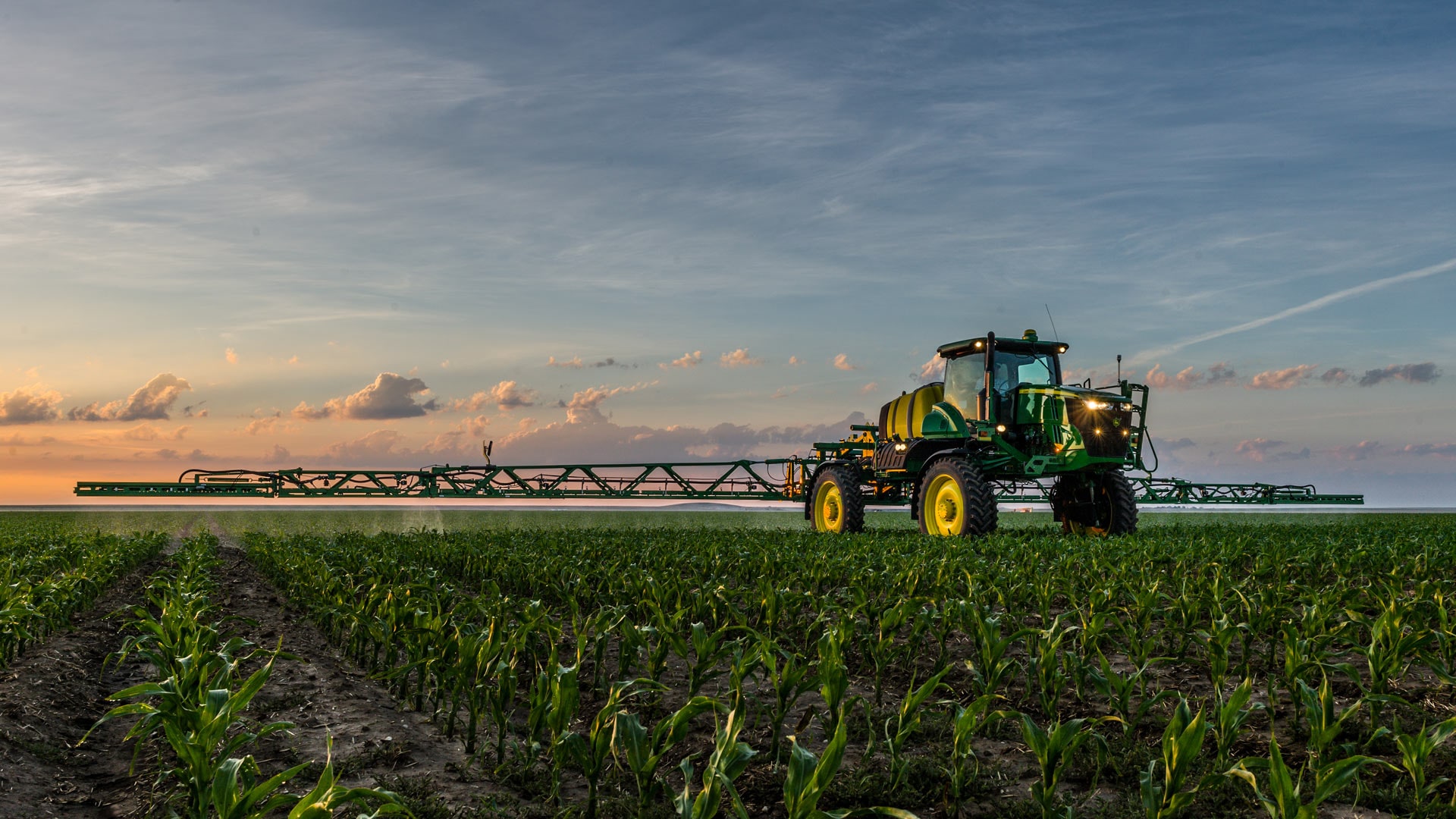 variable rate application photo tractor spraying in field