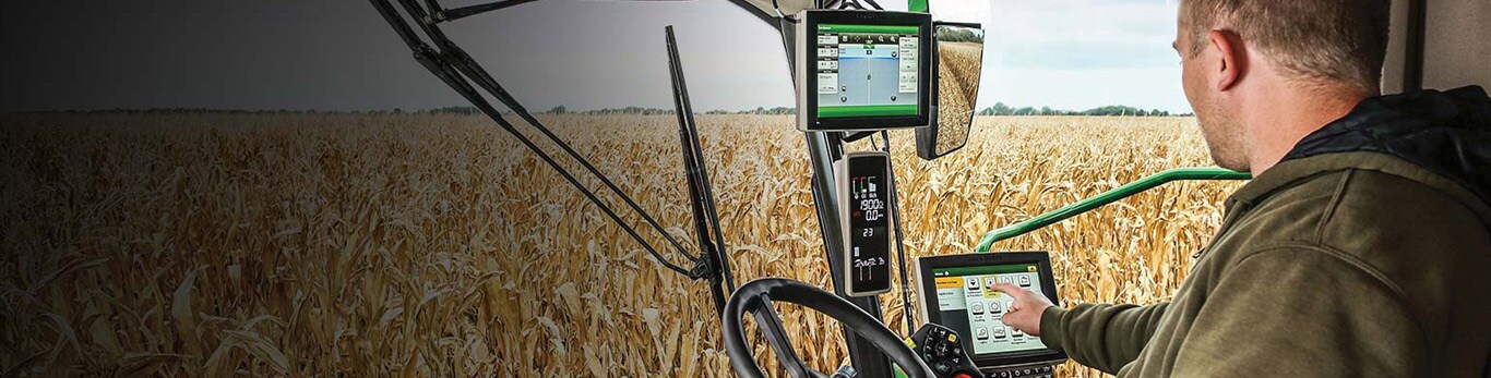 Farmer interacting with precision ag technology in tractor cab