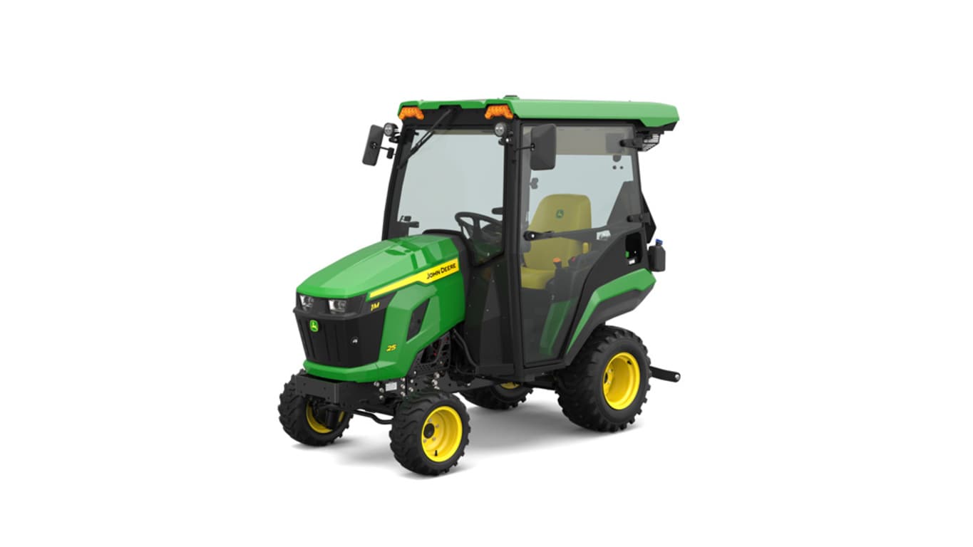 Front-left-facing studio shot of a green HVAC cabbed compact tractor on a white background.