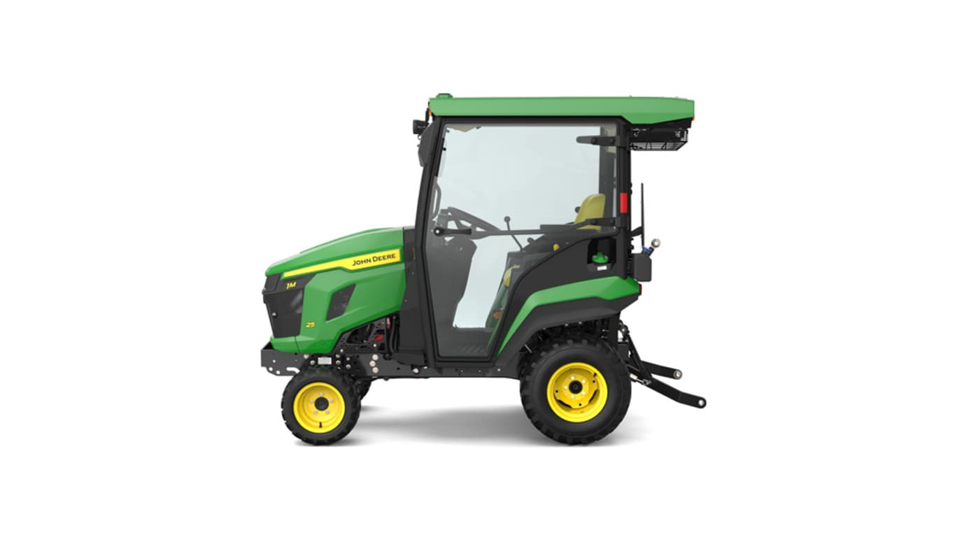 Left-facing studio shot of a green HVAC cabbed compact tractor on a white background.