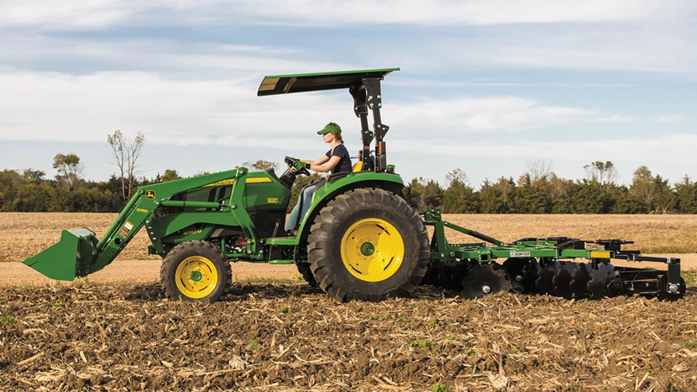 person tilling a field operating a 4052m