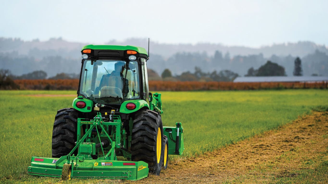 person tilling a field operating a 4052r