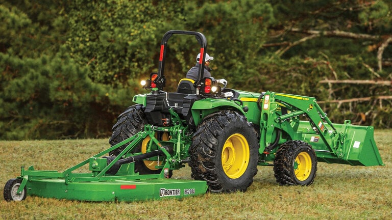 person mowing a field operating a 4066m heavy duty