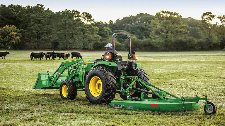 person mowing a field operating a 4066m heavy duty