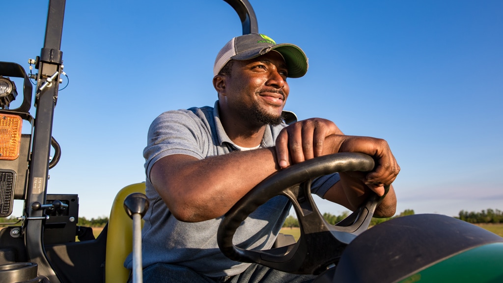 man on tractor looking out across field