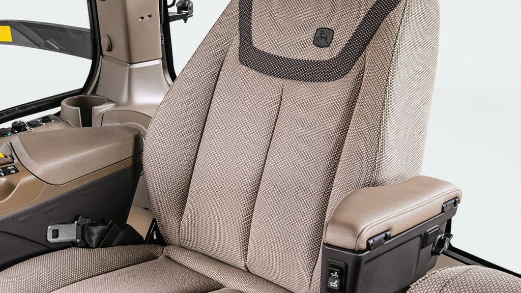 A cloth seat inside the John Deere 8 Series Tractor cab