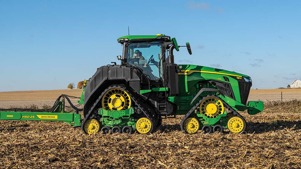 John Deere 8RX 410 Tractor pulling a HSD25 High Speed Disk in a field 
