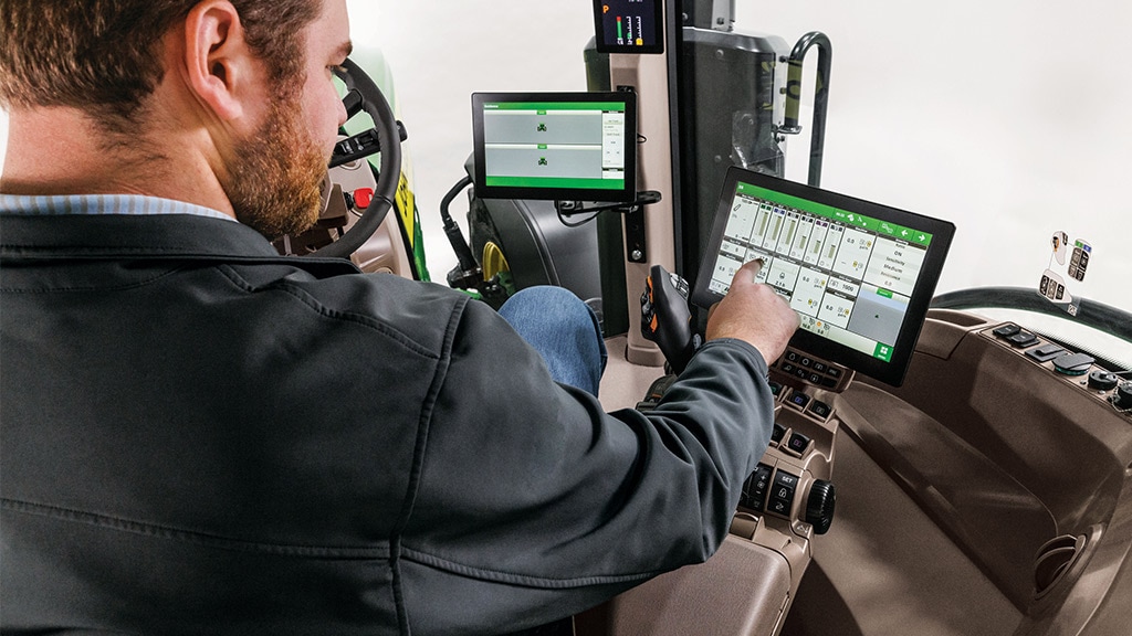 Man interacting with G5 Display in tractor cab
