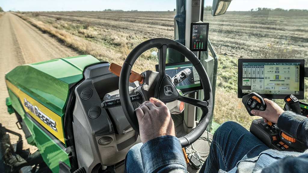 In-cab view of operator driving a high-horsepower 8 Series Tractor. In-cab view of operator driving a high-horsepower 8 Series Tractor.