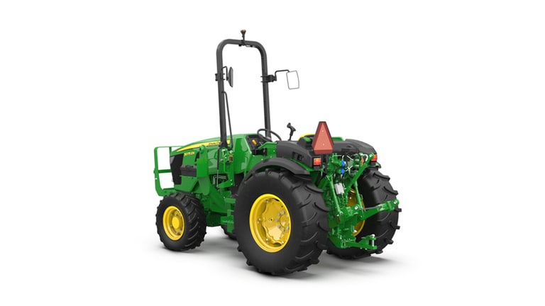 Green and yellow tractor with large rear tires, roll bar, and slow-moving vehicle sign.