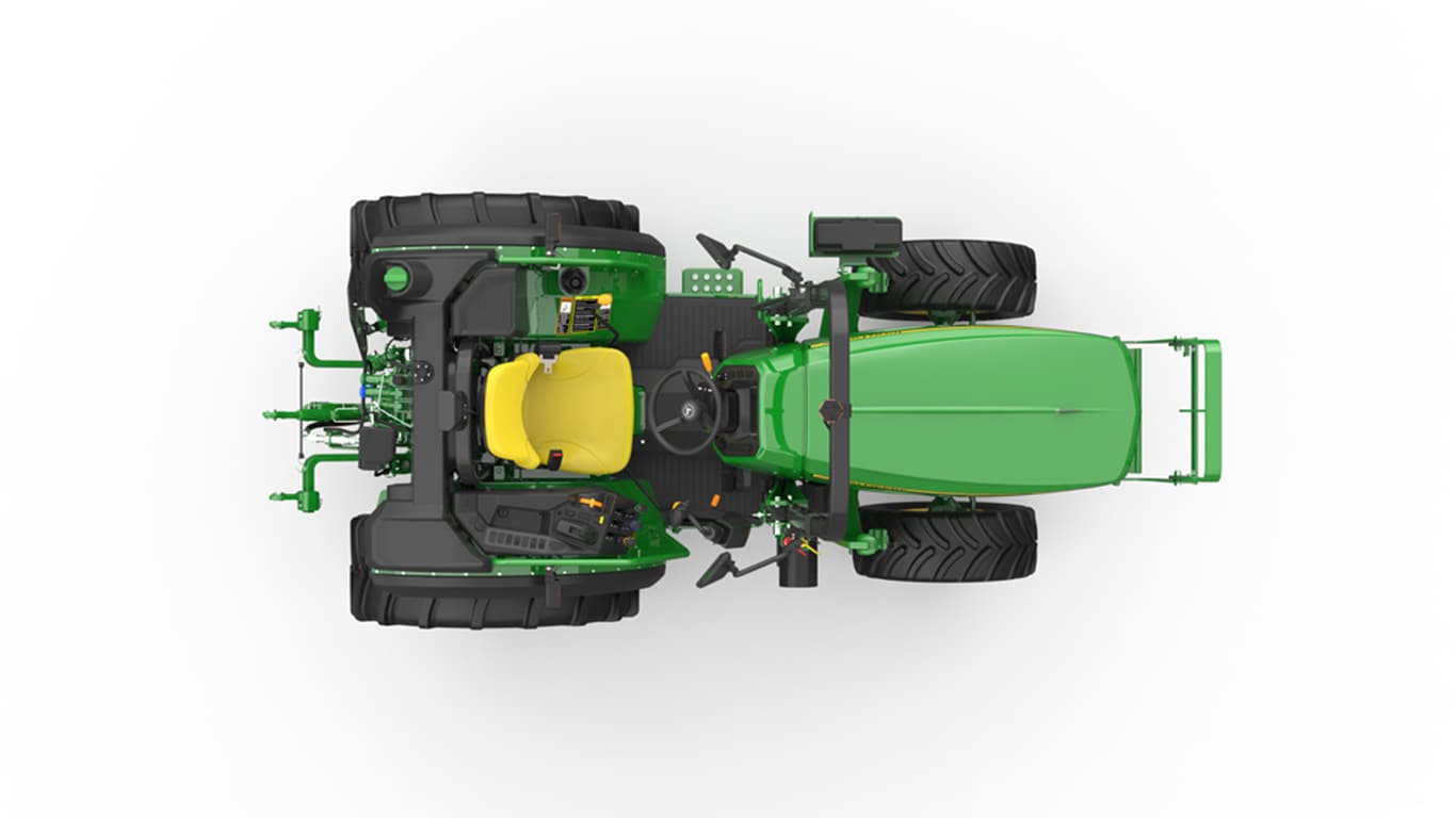 Top view of green tractor with large black tires and yellow seat on white background.