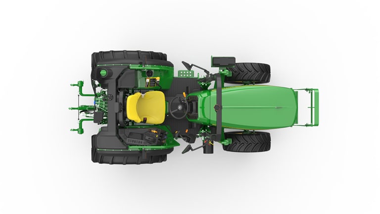 Top view of green tractor with large black tires and yellow seat on white background.
