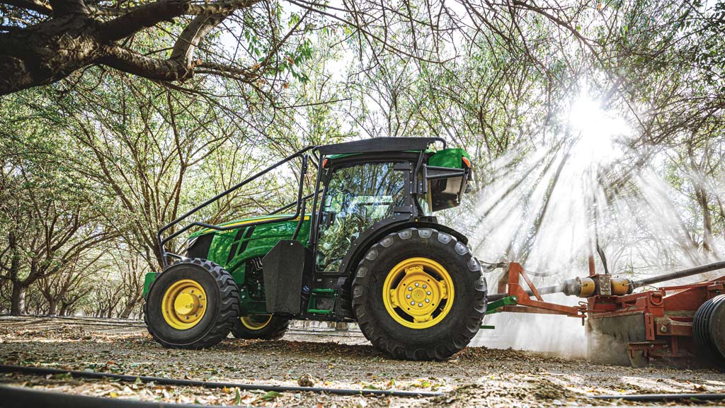 5130ML pulling a sprayer in an almond orchard