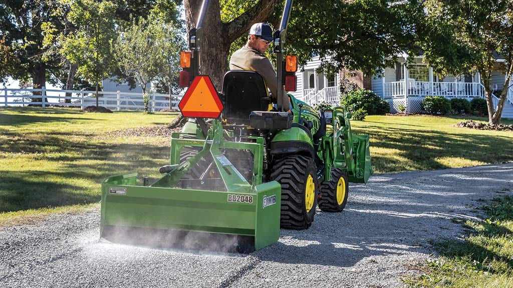 1025R Compact Tractor using D120 loader to lay gravel to make a path