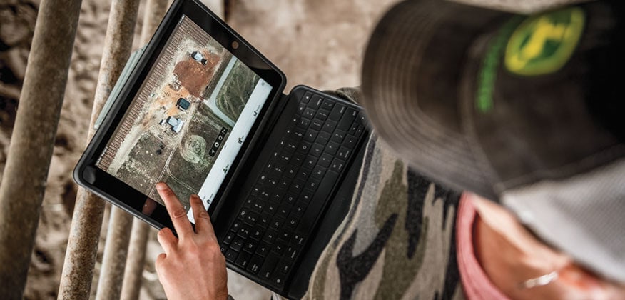 woman looking down at a laptop display