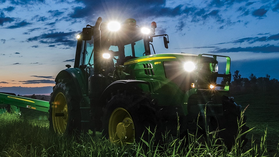 evening shot of 6m tractor with lights on