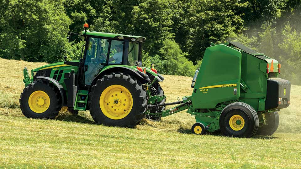 image of 6m tractor in field with baler attachment