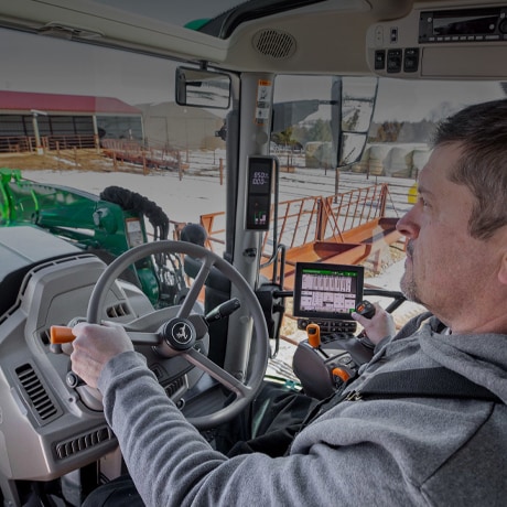 person driving in tractor cab