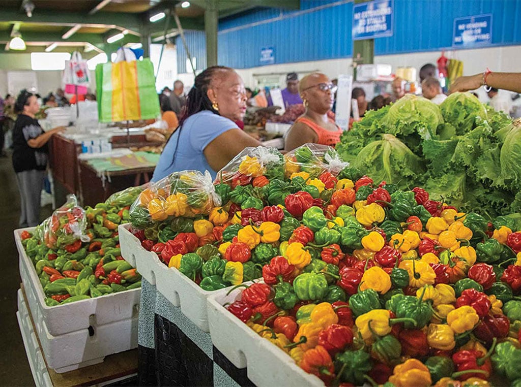 women and peppers in market