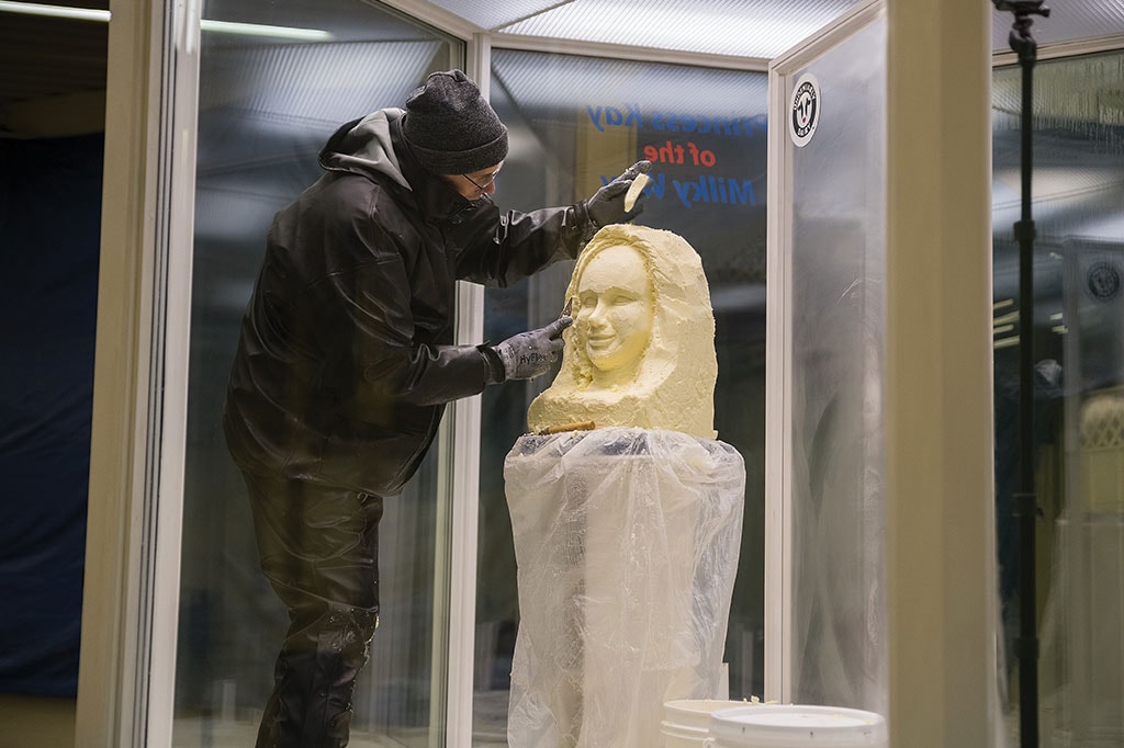 Sculptor Gerry Kulzer carves Brenna Connelly’s butter likeness in the cooler in the Minnesota State Fair Dairy Building.