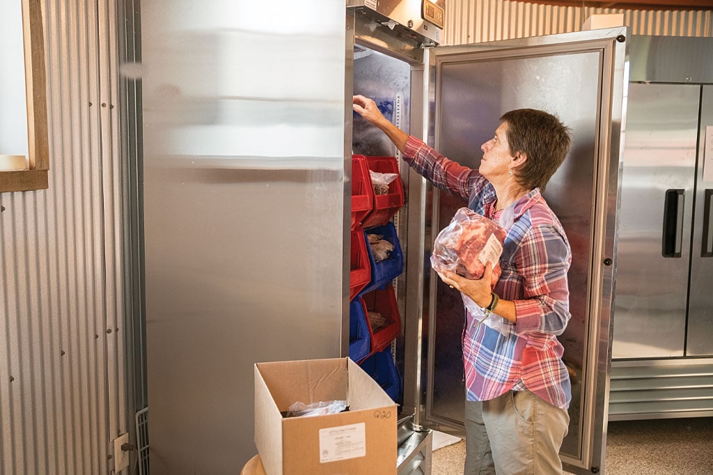 women in her kitchen in the refrigerator